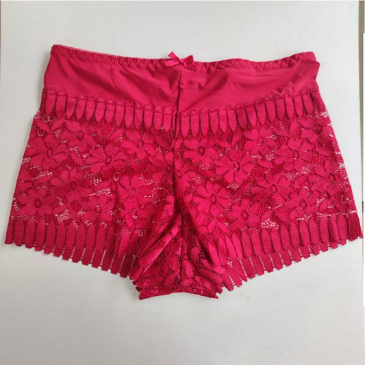 Pink lace shorts on a light gray background