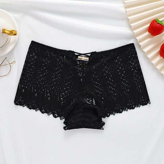 Black lace underwear on a white fabric background with decorative elements.