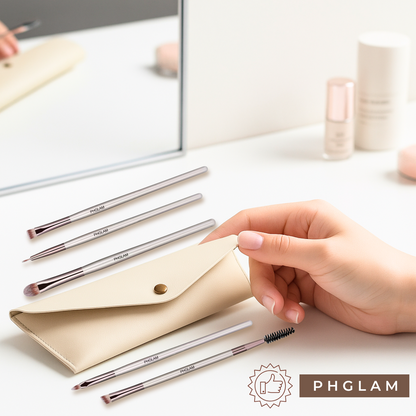 Set of makeup brushes with a beige pouch on a light surface, featuring the PHGLAM brand.