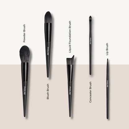 Set of makeup brushes with labels on a beige background