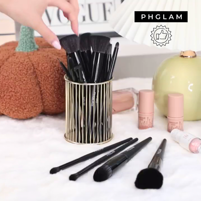 Makeup brushes in a holder with 'PHGLAM' branding on a decorative background