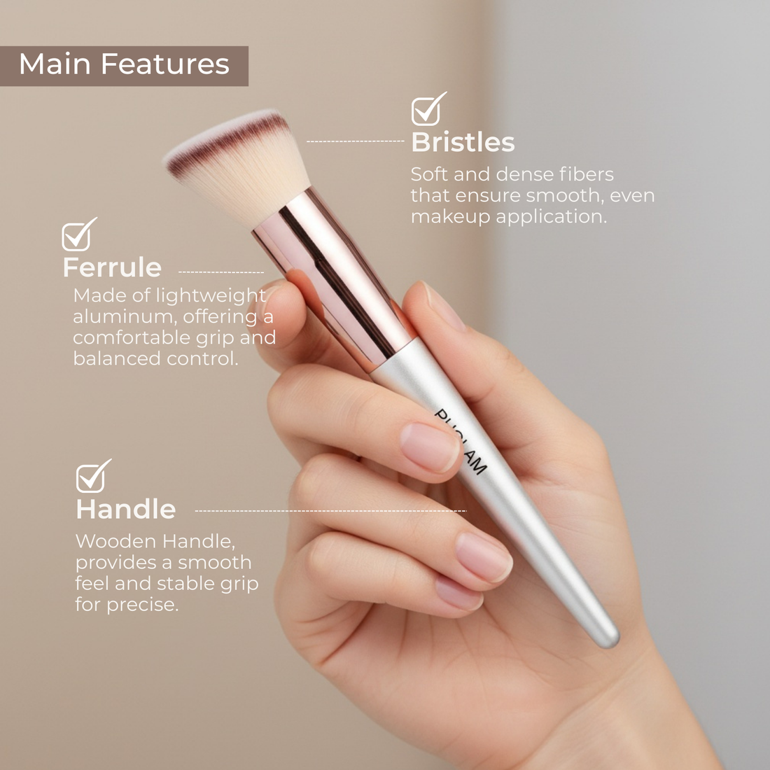 Makeup brush held in a hand with labeled features on a neutral background
