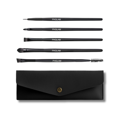 Set of black makeup brushes with a black case on a white background