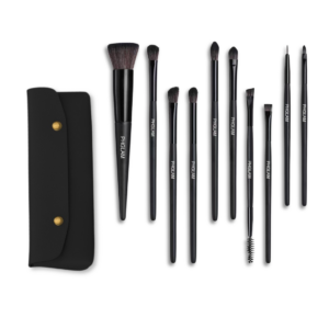 Set of black makeup brushes with a black case on a white background
