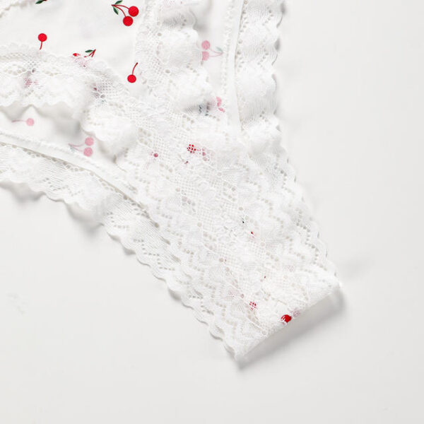 White textured fabric with red and pink floral patterns on a light gray background